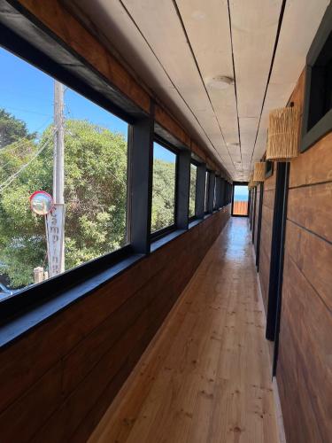 an empty hallway with windows on the side of a train at Hotel Pacífico in Matanzas