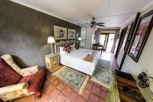 a bedroom with a bed and a couch at Fish Eagle Manor in East London