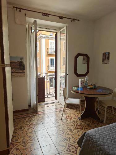 a room with a bed and a table and a mirror at Casa in Piazza in Fondi