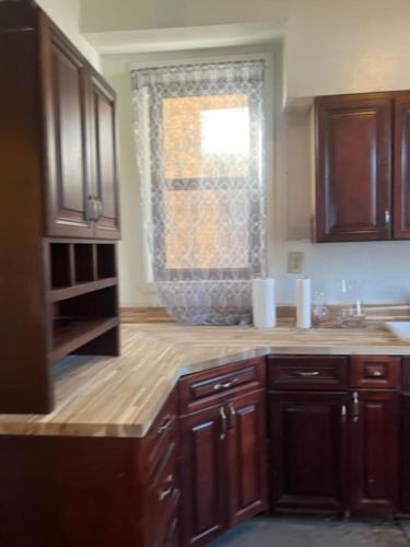 a kitchen with wooden cabinets and a window at Valley and city views in Steubenville
