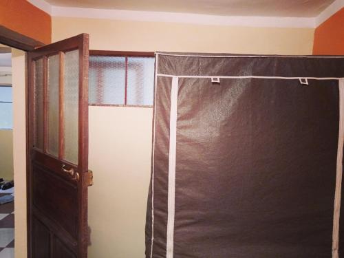 a bed with a canopy in a room with a window at Aparment equipped and independent in La Paz