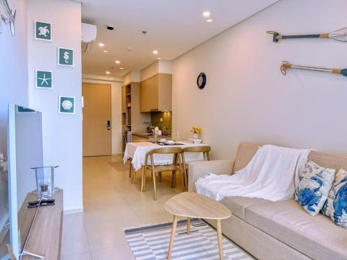 a living room with a couch and a table at A cozy condotel in Bai Sau(1 bed and 1 sofa bed) in Vung Tau