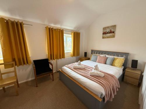 a bedroom with a large bed and a chair at Doctors, Nurses, Families and contractors welcome in Huntingdon