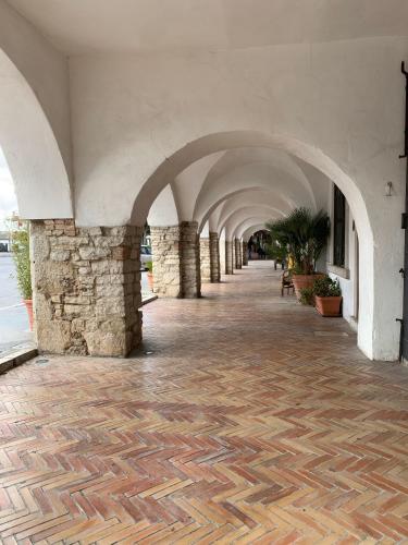 a hallway with a stone wall and an arcade at Casa Virgilio in Venosa