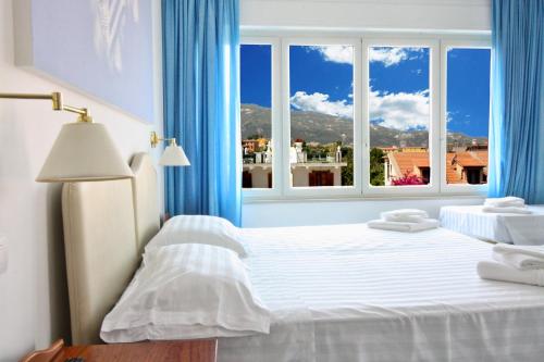 a bedroom with a bed and a large window at Maison Tonina Sorrento Coast in Sant'Agnello