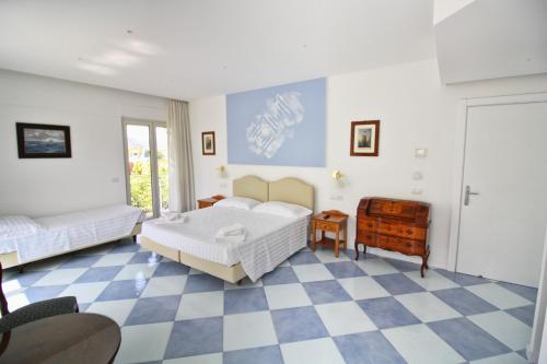 a bedroom with two beds and a checkered floor at Maison Tonina Sorrento Coast in Sant'Agnello