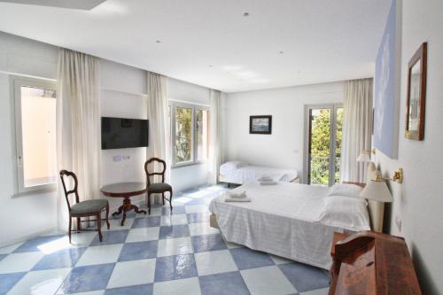 a bedroom with a bed and a table and chairs at Maison Tonina Sorrento Coast in Sant'Agnello