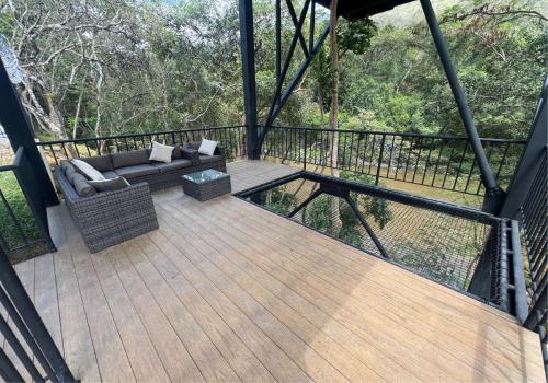 a screened in deck with a couch and a table at Hotel San Gil House in San Gil