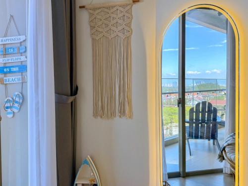 a room with a mirror and a view of a balcony at A cozy condotel in Bai Sau(1 bed and 1 sofa bed) in Vung Tau