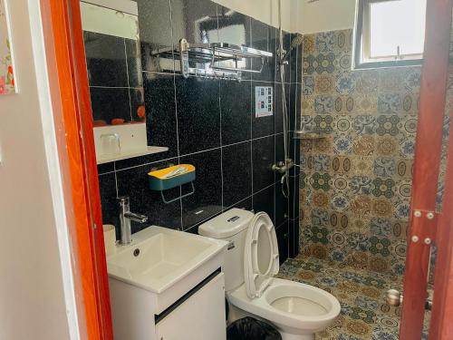 a small bathroom with a toilet and a sink at Oriana Dalat in Da Lat