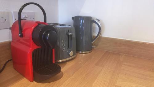 two suitcases sitting next to each other on a wooden floor at The Skyview Apartment near Media City & Old Trafford Stadium with Paid Gated Parking, 500Mbps Internet & Netflix in Manchester