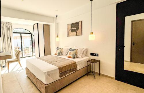 a bedroom with a bed and a large window at Sirena Bay Beach House and Luxury Suites in Protaras
