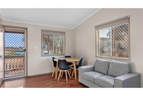 a living room with a couch and a table at Discovery Parks - Port Hedland in Port Hedland