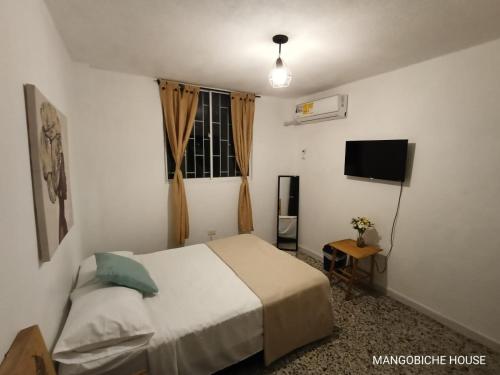 Postel nebo postele na pokoji v ubytování MANGO BiCHE - HOUSE