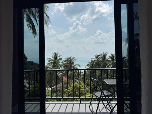 a view of the ocean from a balcony at Tanouy Garden in Baan Khai