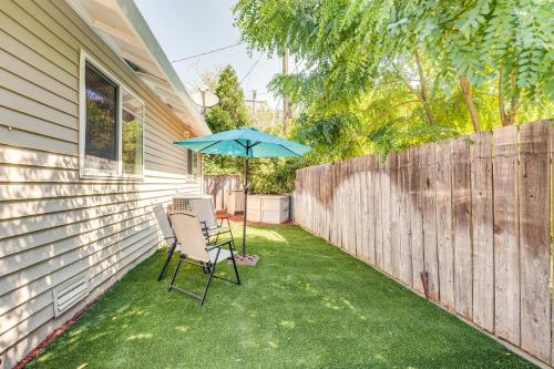a patio with two chairs and an umbrella at Sunny Lodi Getaway - Walk to Downtown and Wineries in Lodi