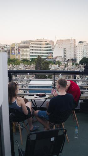 a group of people sitting at a table on a ship at MONS hostel in Buenos Aires