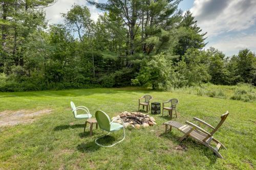 a group of chairs sitting around a fire in a field at Franconia Escape on Half Acre with Fire Pit and Deck! in Franconia