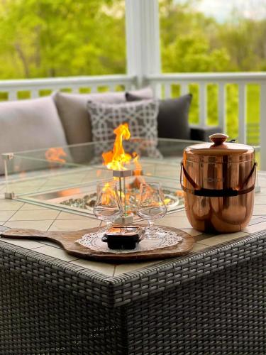 a table with two wine glasses and a pot at Pillow and Paddock B&B in La Grange