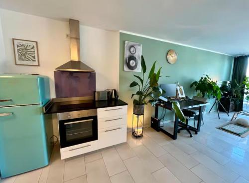 a kitchen with a refrigerator and a table in a room at Penthouse-Apartment am Schloss in Brühl