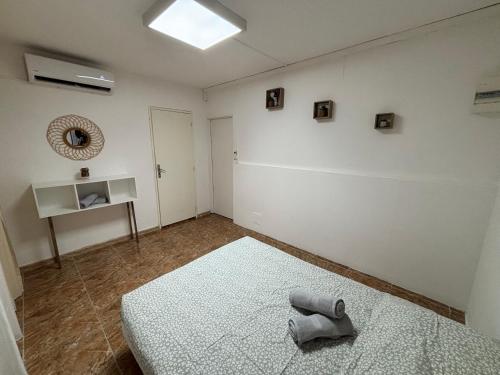 a room with two beds and a white wall at T2 ZEN Climatisé à Acajou Lamentin in Le Lamentin