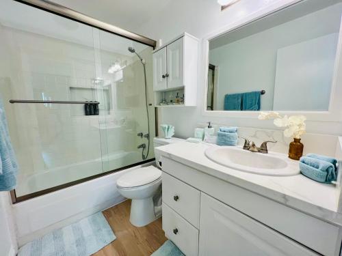a white bathroom with a sink and a shower at Oceanfront 2BR 2BA with Stunning View 333 in Redondo Beach