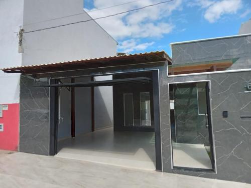 a rendering of a house with an open door at Nelio anl in Governador Valadares