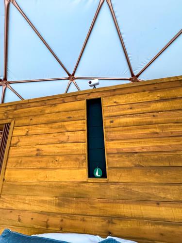 a building with a window with a green light at Luahara Glamping Tapalpa - Domo Natural Experience in Tapalpa