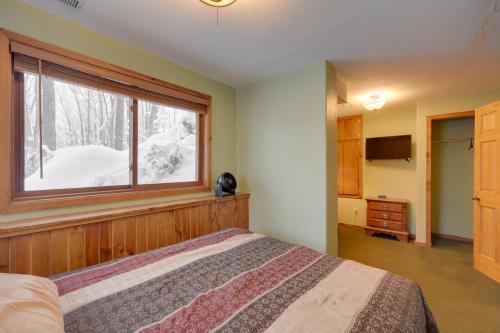 a bedroom with a bed and a window at Waterfront Nelson Lake Cabin with Boat Dock! in Hayward