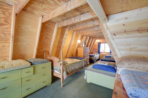 a bedroom with two bunk beds in a log cabin at Waterfront Nelson Lake Cabin with Boat Dock! in Hayward