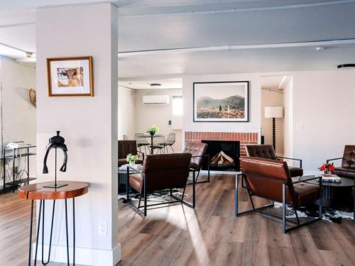 a living room with chairs and a fireplace at Western Lodge in Steamboat Springs
