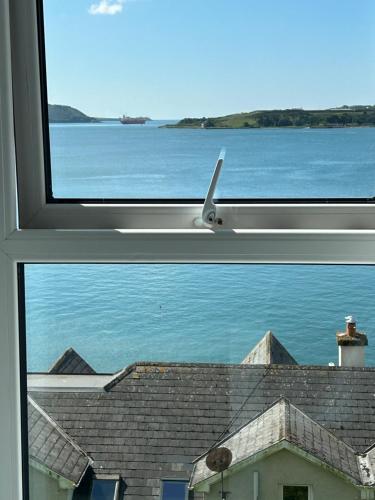 a window with a view of the ocean from a house at KCM Urban Retreats in Cobh