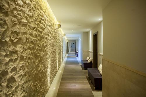 a hallway of a hotel with a stone wall at Domaine de Verchant & Spa - Relais & Châteaux in Montpellier
