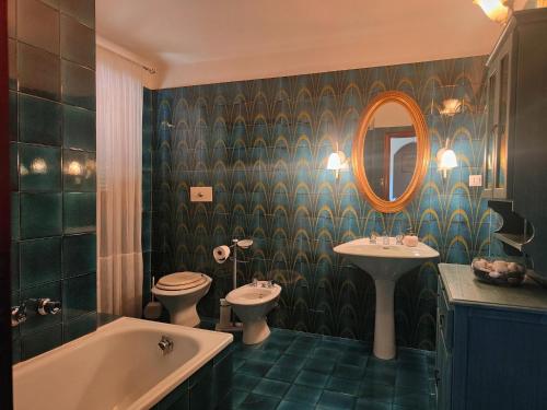 a bathroom with two sinks and a tub and a mirror at Holiday Home Camaiore near Lido Beaches in Camaiore