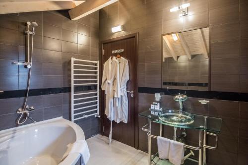 a bathroom with a tub and a sink at Villa Vuchev in Velingrad