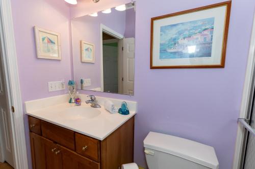 a bathroom with a sink and a toilet and a mirror at 5 Bedroom Home in Old Homestead II in Huron