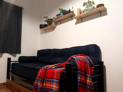 a blue couch with a blanket on top of it at Casa Azul in Villa del Dique