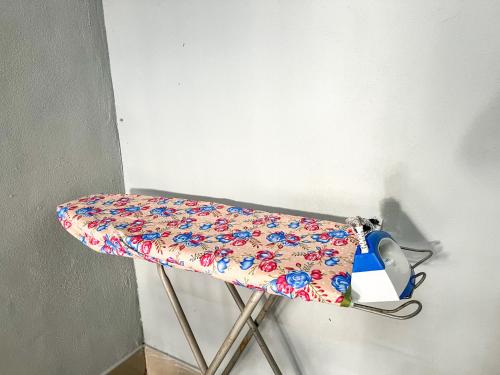 a chair with a floral sheet on it at Budget Rest House Padang Besar in Padang Besar