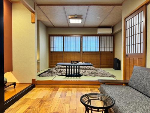 a living room with a table and a couch at Oyado Koto No Yume in Takayama