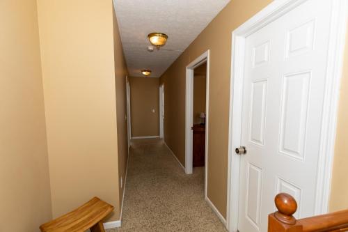 a hallway of a home with a white door at 5 Bedroom Home in Old Homestead II in Huron