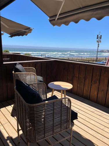 a patio with chairs and a table and the beach at Hotel Pacífico in Matanzas