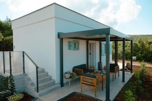 a small house with a gazebo at Seaside house for families with children Cove Nevidjansko Polje, Pasman - 24036 in Neviđane
