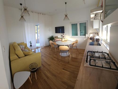 a living room with a couch and a table at Seaside house for families with children Cove Nevidjansko Polje, Pasman - 24036 in Neviđane