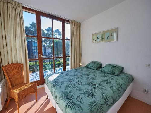 a bedroom with a bed and a large window at Peaceful Villa in Castle Park in Salles