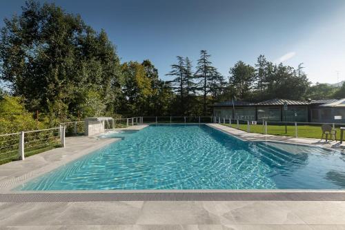 a large swimming pool with blue water at Hotel Terme Salvarola in Sassuolo