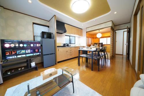 a living room with a kitchen and a dining room at KAMON relaxing, Japanese spacious room in Osaka