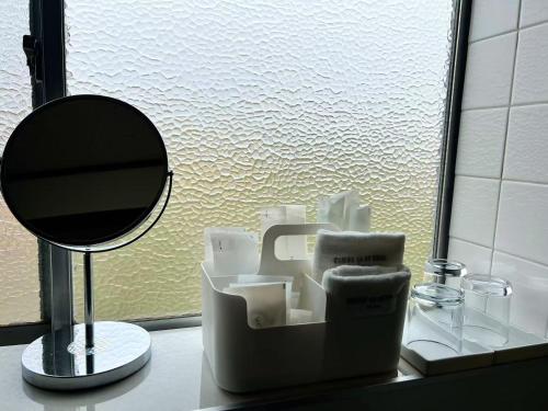 a bathroom counter with a mirror at 飯野小屋 in Marugame