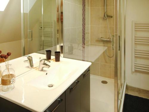 a white bathroom with a sink and a shower at Country House in Normandy near D-Day Beaches in Brucheville