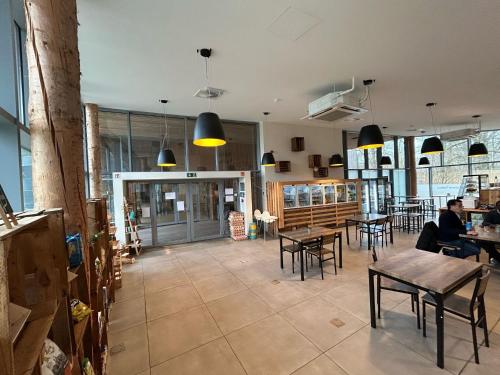 a restaurant with tables and chairs and people sitting at tables at Forest-View Mansion, Hainaut in Antoing