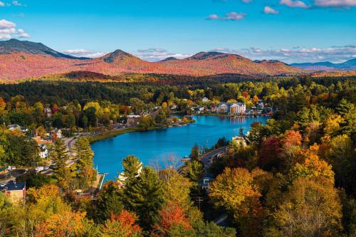 a city in the fall with a lake and mountains at voco Saranac Lake NY - Waterfront by IHG in Saranac Lake
